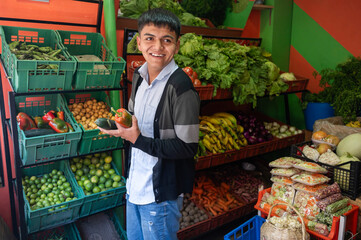 Young man working at the local fruit shop in Latin America