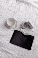 tablet and headphones on the bed top view- Image