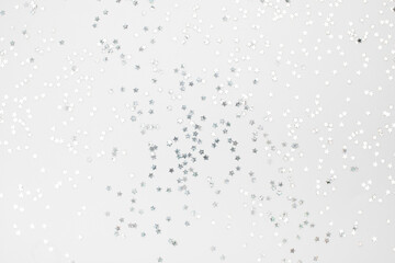 sparkles silver stars on white background with text place- Image