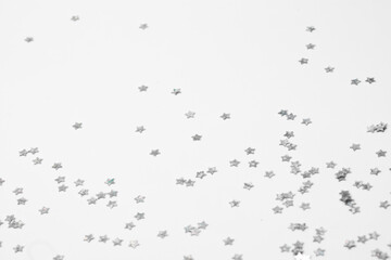 sparkles silver stars on white background with text place- Image
