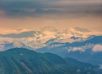 Mountain landscape after a storm. Autumn landscape, forested and rocky hills of fog, rain and clouds.
