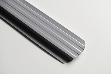 Metal siding for fence, roof, blinds, metal profile isolated on white background close-up