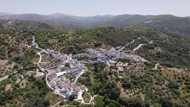 Aerial view of a mountain village in Spain with lush greenery and picturesque landscape, Juscar, Malaga, Andalucia, Spain