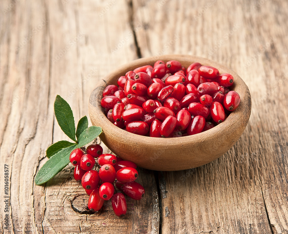 Wall mural Barberry berries in wooden plate