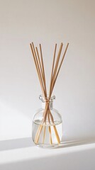 Glass essential oil diffuser with wooden sticks isolated on white background