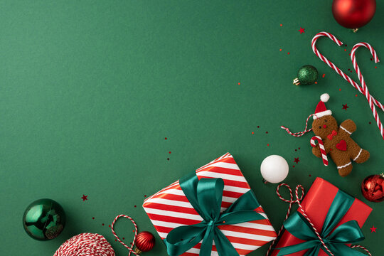 Stylish Christmas scene featuring wrapped gifts, candy canes, ornaments, and festive decorations on a green backdrop creating a warm holiday atmosphere