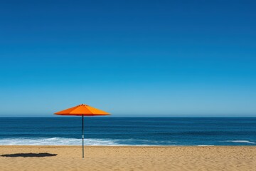 Serene beachscape with single orange umbrella