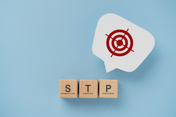 STP text ,abbreviation for Segmentation, Targeting, Positioning  on wooden cube blocks. Dartboard...