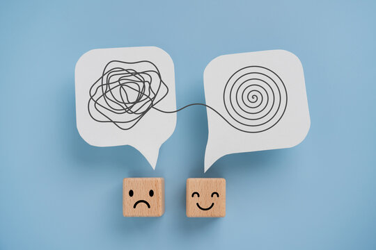Mental health, brain disorder, World mental health day, Alzheimer, Psychology concept. Tangle of thoughts and clear line on real   white speech bubbles paper cut and emoticon face on cube blocks