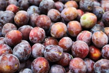 Ripe plums in a store, fresh autumn harvest