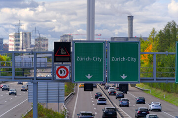 High angle view of multi-lane highway with road signs and heavy traffic between Swiss cities of Zürich and Wallisellen on an autumn day. Photo taken October 5th, 2024, Zurich Wallisellen, Switzerland.