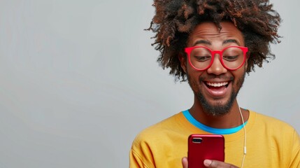 horizontal shot of pleasant looking black adult, excited with video chat, carries up to date cell phone
