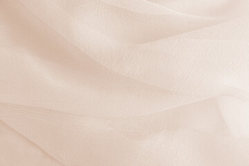 Abstract festive, wedding background with soft waves of chiffon fabric. Delicate pastel beige...