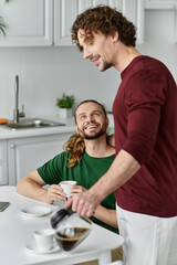 Two partners share laughter while brewing coffee in their warm kitchen.