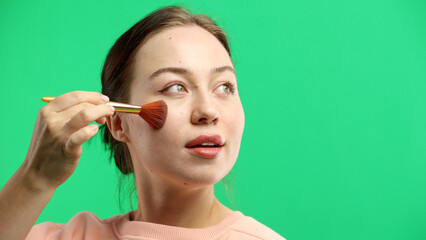 Woman's face, close-up, on a green background