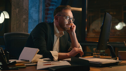 Tired lazy man male manager business bored work online computer in dark night office Caucasian mature stressed exhausted fatigued businessman need energy guy overworked exhaustion late time deadline