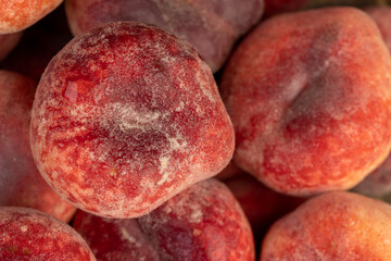a pile of ripe washed peaches on the table