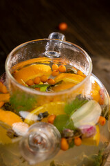 tea with orange and ripe sea buckthorn berries