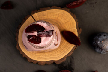 plum yogurt with slices and whole fruits on the table