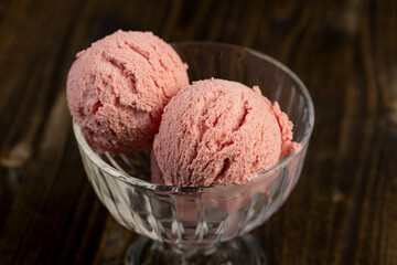 red strawberry-flavored ice cream in a glass bowl