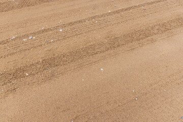 close-up of a part of a wet road without asphalt