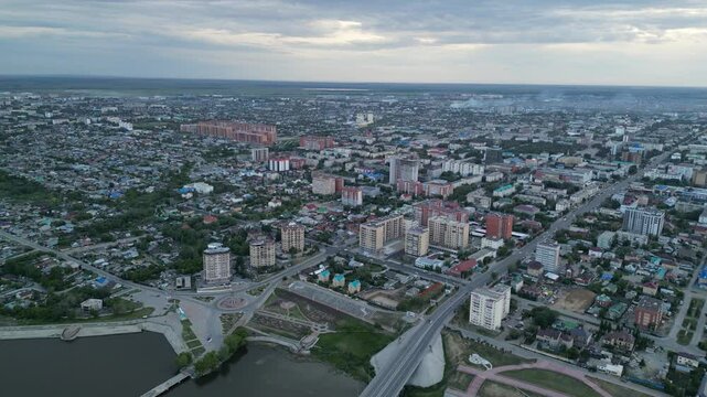 Kostanay, Kazakhstan - 06.04.2024 : A transport bridge over the Tobol River. View of the city. The view from the drone.