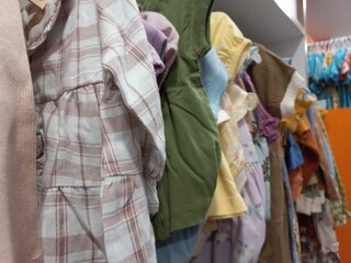 Hangers for various kinds of baby clothes sold in the shop