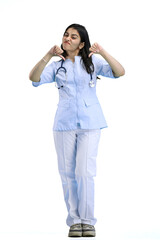 A female doctor, full-length, on a white background, shows her thumbs down