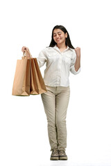 A woman, full-length, on a white background, with bags