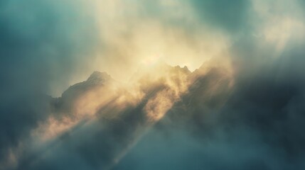 Sunrays break through misty clouds over jagged mountain peaks, creating a mystical atmosphere of serenity and wonder.