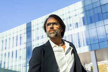 Businessman looking away in a modern city setting