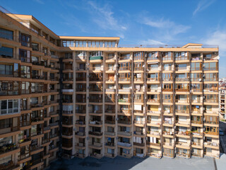 Aerial view of modern residential high-rise buildings with balconies and outdoor areas. The clean, geometric design of the apartments highlights contemporary urban living. Shot with a drone