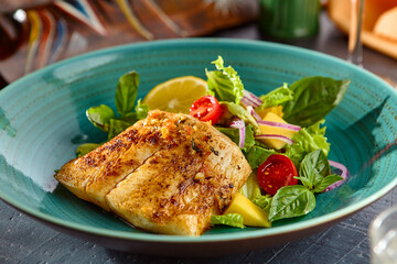 White Fish Steak with Fresh Vegetable Salad Delight in Vibrant Cerulean Dish – Bright and Gourmet Presentation