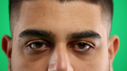 Man's eyes, close-up, on a green background