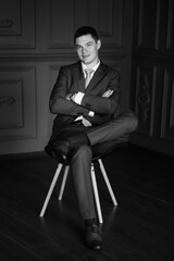 portrait of groom in blue three piece suit with tie on wedding day