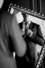 portrait of groom in blue three piece suit with tie on wedding day