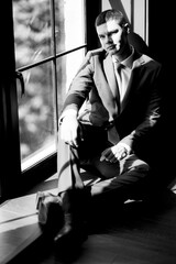 portrait of groom in blue three piece suit with tie on wedding day