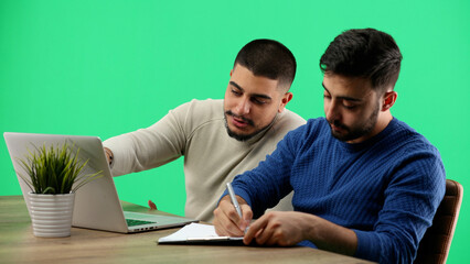 Obraz premium Men, close-up, on a green background, is working