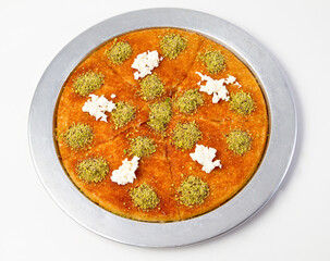 Künefe is a traditional dessert made from cheese pastries soaked in sugar-based sweet syrup. Turkish cheese dessert