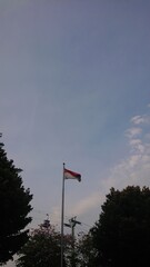 Indonesia Flag at Pole with blue sky

