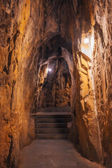 Obraz premium arch inside an ancient limestone Vietnamese cave in the Marble Mountains in Da Nang in Vietnam in Asia