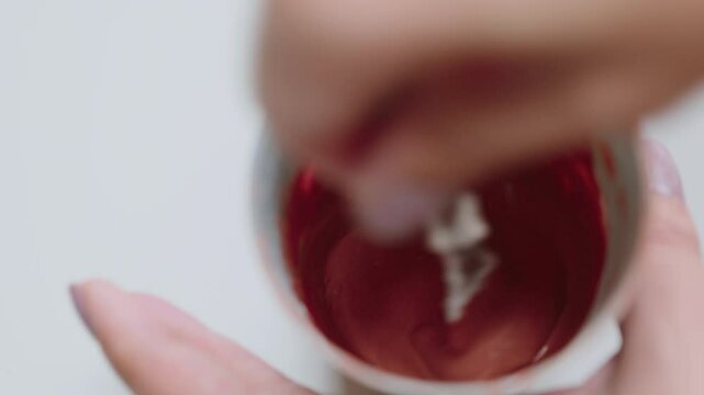 Terracotta Colored Liquid Swirling in a Cup, Close-Up View