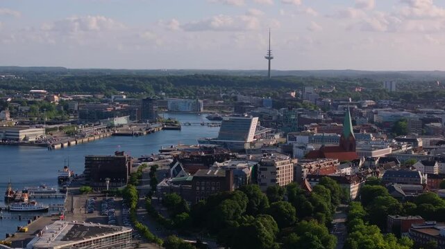 Camera panning over the city of Kiel, Germany. The Kiel fjord and harbor are visible, as well as the telecommunications tower