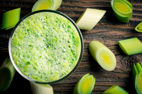 Fresh leek juice on wooden table
