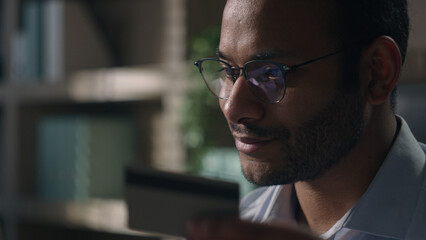 Close up joyful happy man office worker in glasses shopping online with computer businessman with...