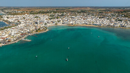 Obraz premium Aerial view Porto Cesareo, a small city on the Mediterranean Sea in the province of Lecce in Puglia, Italy. It is a tourist town located on the Ionian coast of the Salento peninsula.