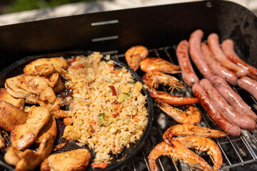 A delicious mix of grilled chicken fried rice shrimp and sausages What a feast