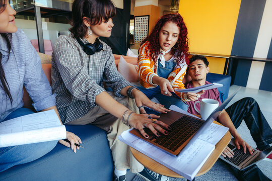 High school students collaborate on a group project, engaged in active learning and teamwork in a modern classroom setting