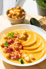 Pumpkin soup with jamon and croutons