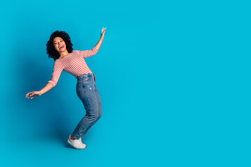 Obraz premium Photo of funky lovely optimistic girl wear stylish clothes falling down empty space isolated on blue color background